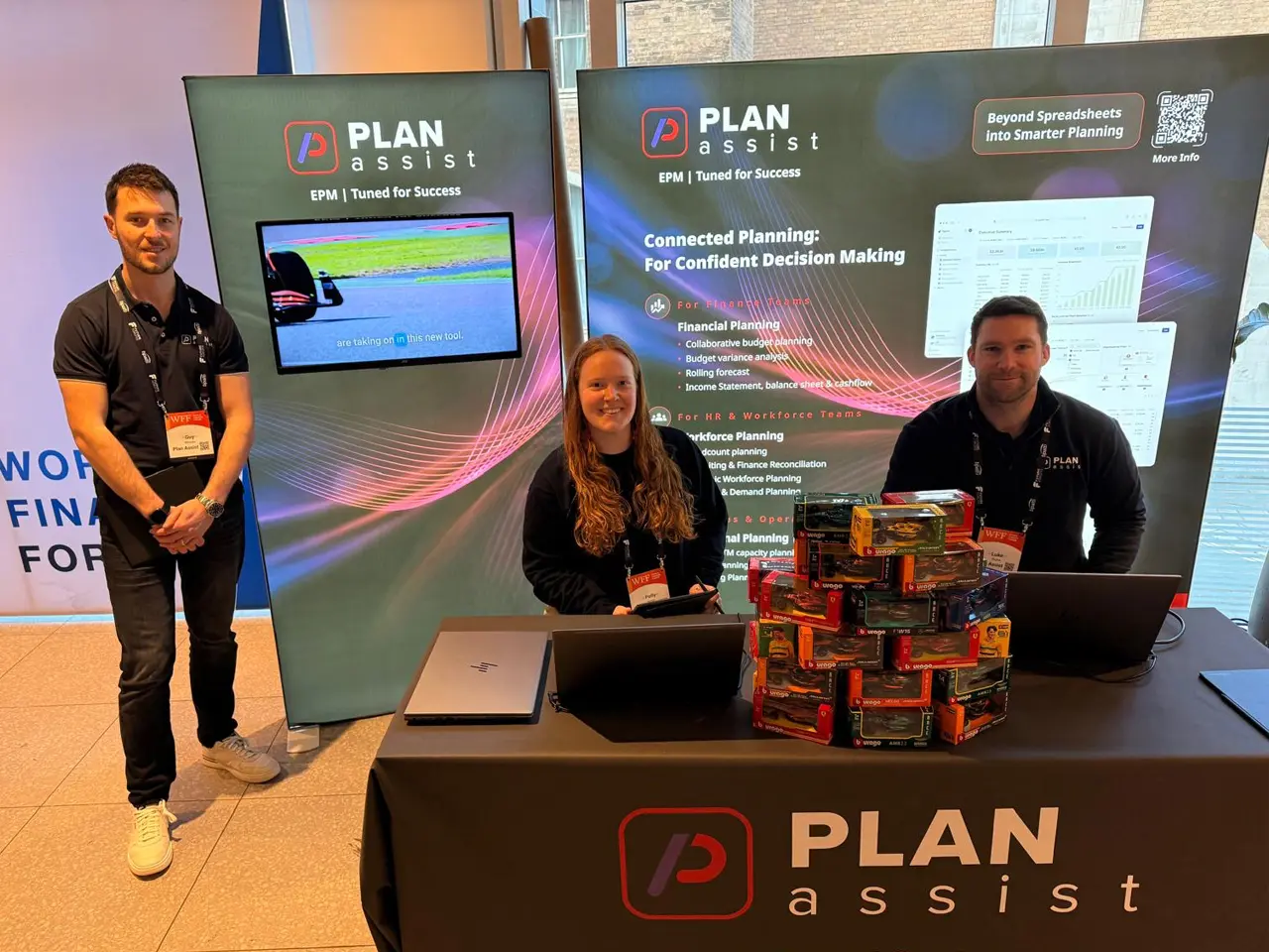 Plan Assist specialist EPM team members at an exhibition stand showcasing financial planning and EPM consultancy services